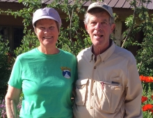 Dick and Gay Sise Grossman ’65 standing in front of flowers